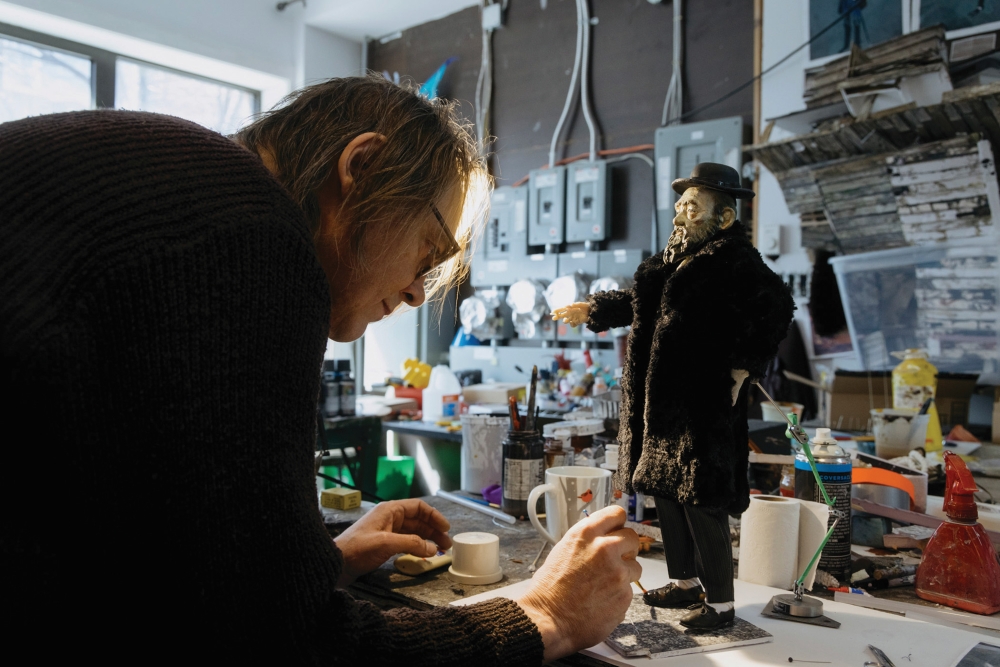 Maciek Szczerbowski puts finishing touches on a puppet for 'The Girl Who Cried Pearls.' [photo: Martin Gros]
