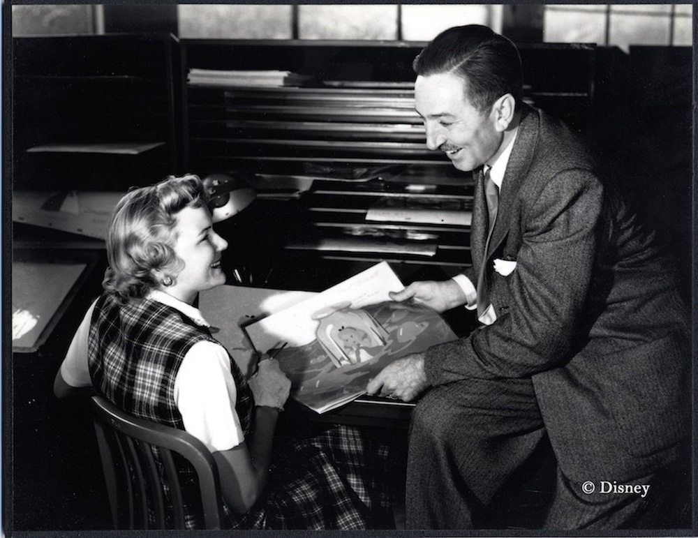 Inker Ginni Mack and Walt Disney review production art for Alice in Wonderland, (ca. 1950).