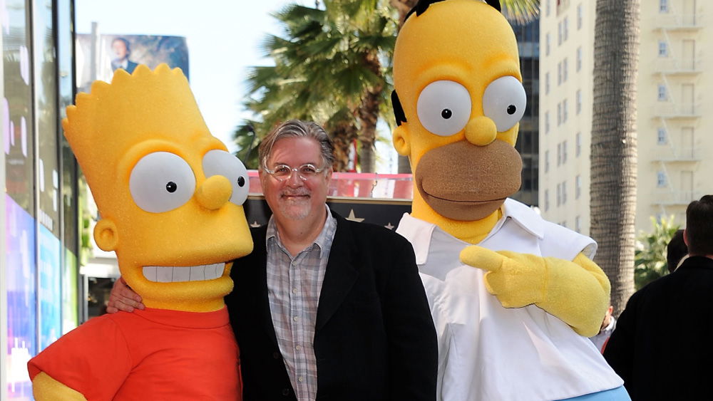 Matt Groening (center) poses with Bart and Homer Simpson [Photo: Valerie Macon/Getty Images]